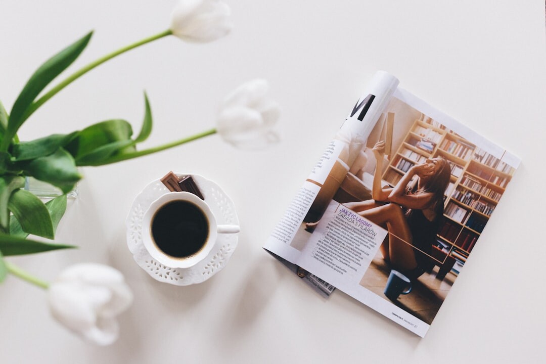 Stack of newspapers and magazines with a coffee cup on a table